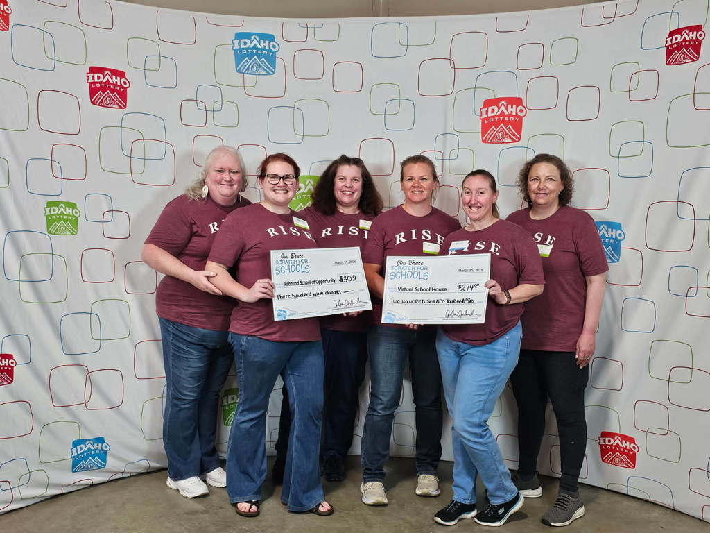 Teachers receiving the money from the Scratch for Schools Success event