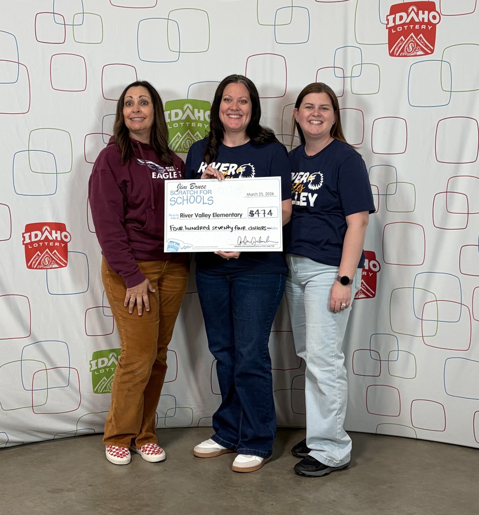 3 women standing and holding a giant check