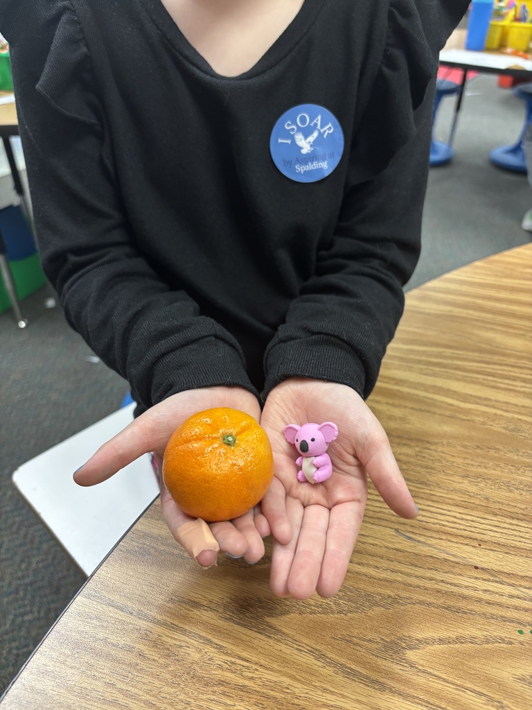 first grader with orange and eraser. prizes from mrs hampton