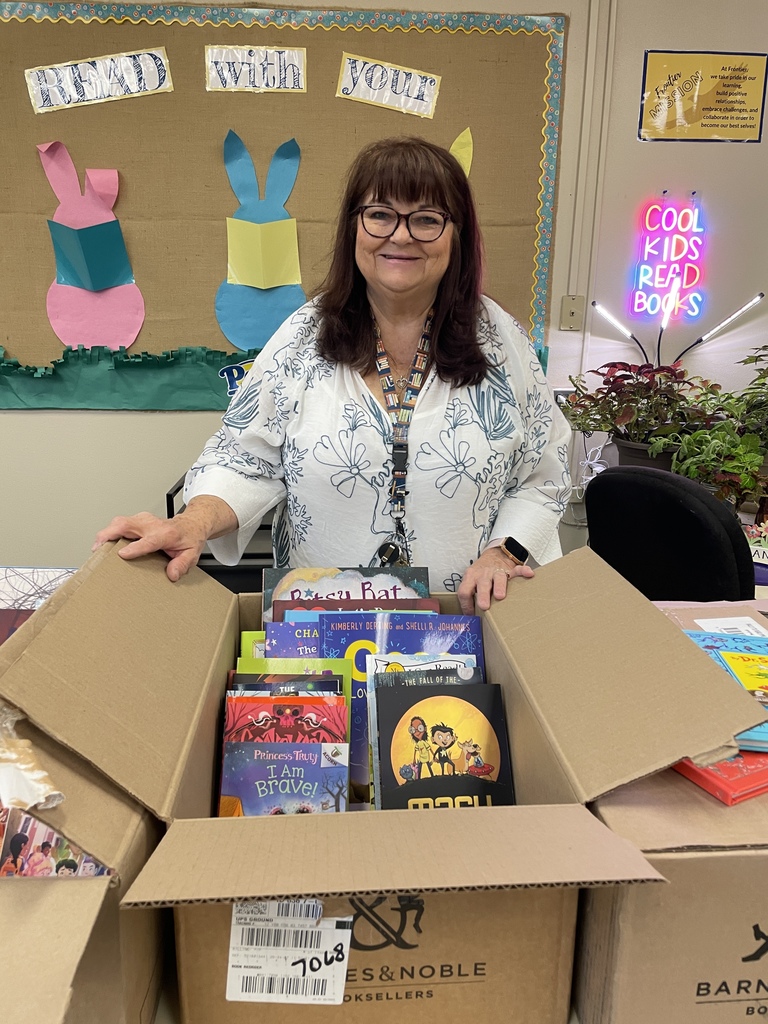 Mrs. Knam opening a box of books from Rally to Read