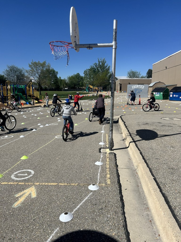 4th graders riding their bikes in the obstacle course.