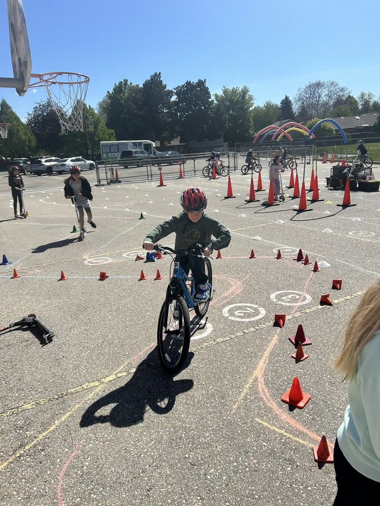 4th grader riding his bike in the obstacle course.