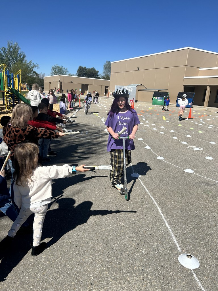 4th graders riding their bikes in the obstacle course.