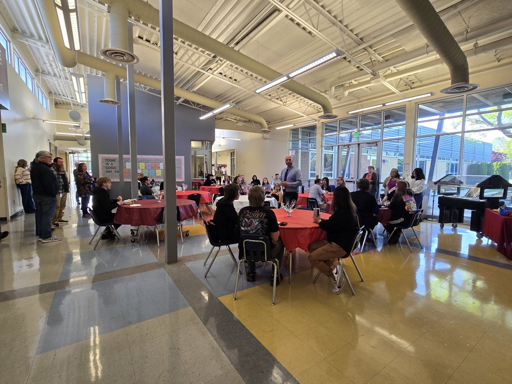Mr. Hanneman talking with students at Breakfast of Champions