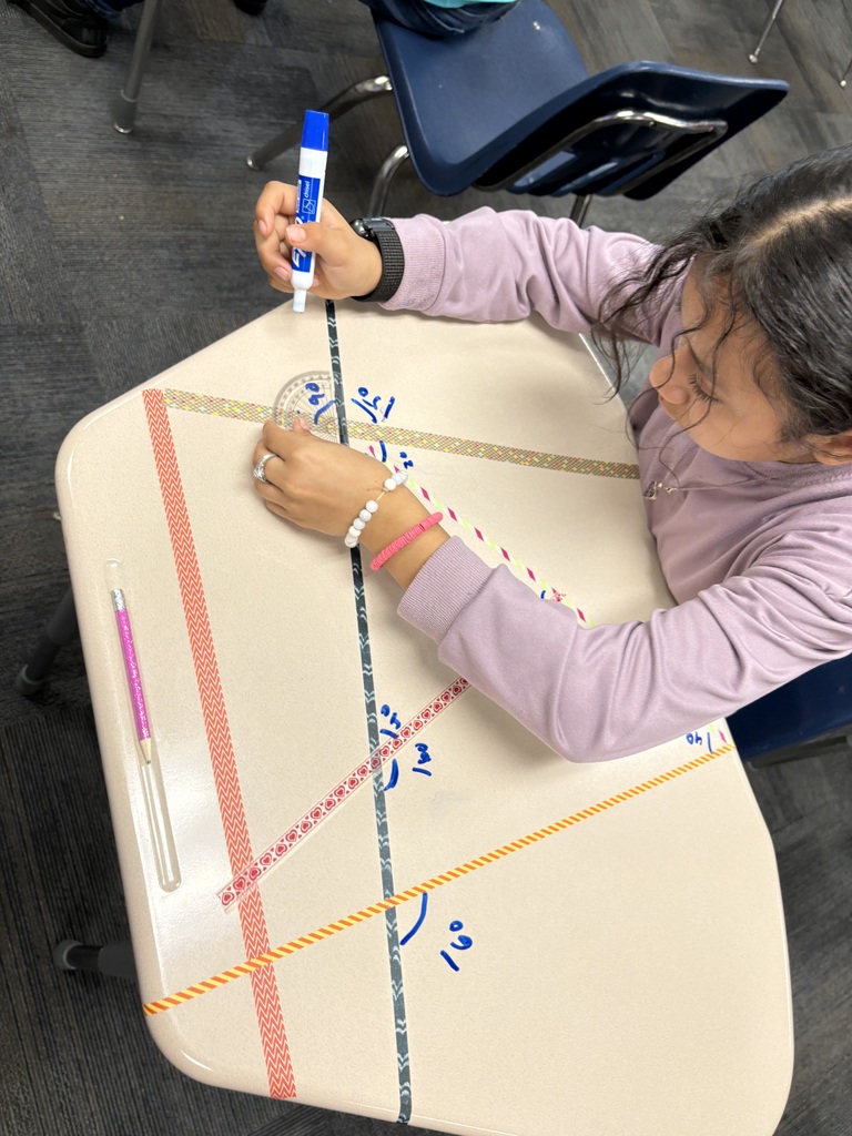 An image of a student measuring angles on a desk 