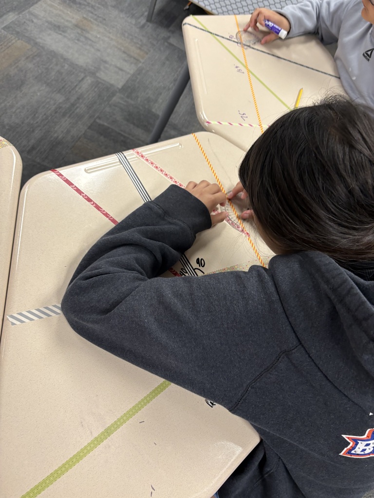 An image of a student measuring angles on a desk 