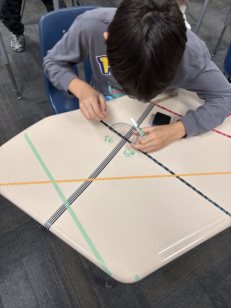 an image of a student measuring angles on a desk