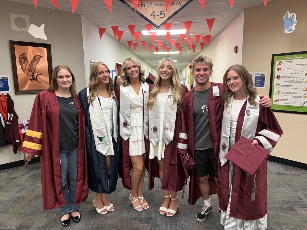 students in hallway in caps and gowns
