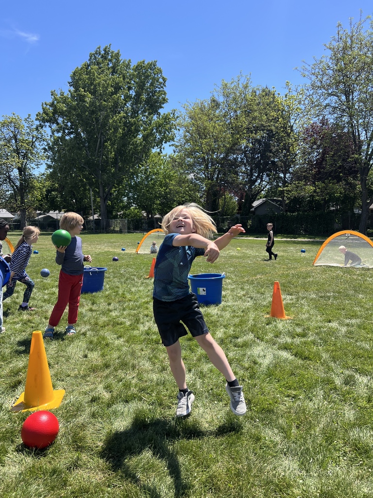 kindergartner throwing a ball at field day
