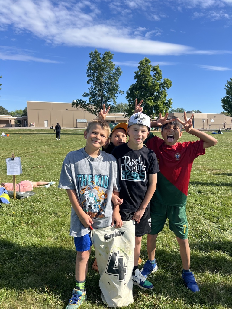 3rd graders posing with "bunny ears" at field day