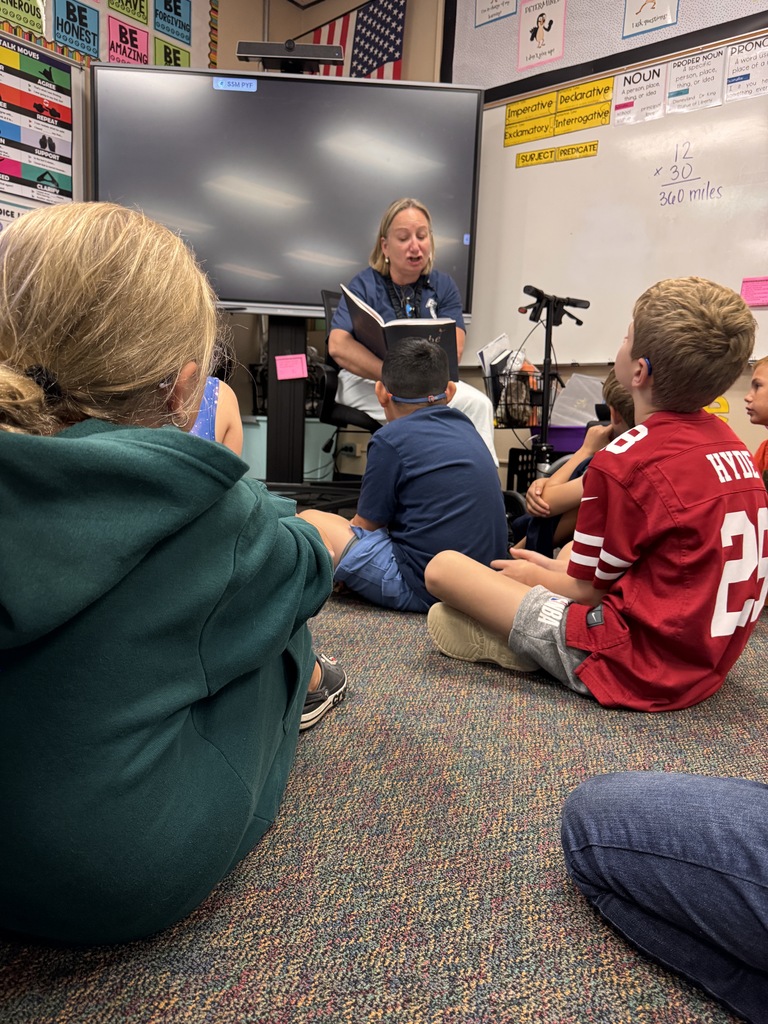 Mrs. Dunlop reading to 4th grade students. 