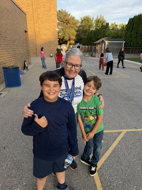 Principal with students on blacktop