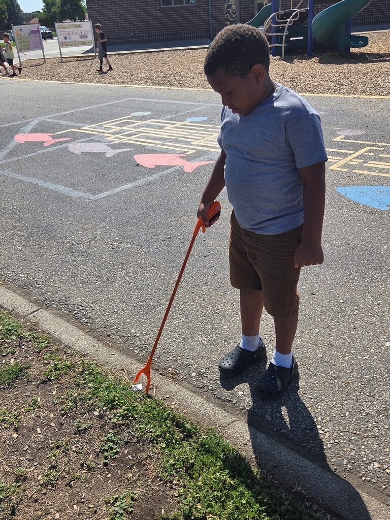 student picking up trash
