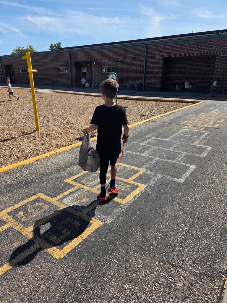 student picking up trash