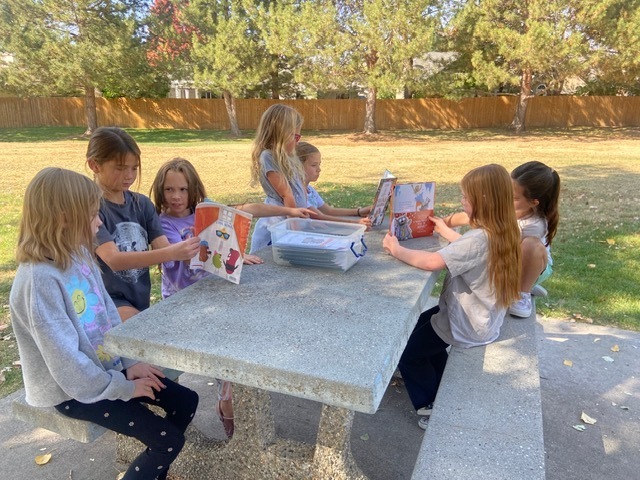 Kids reading outside