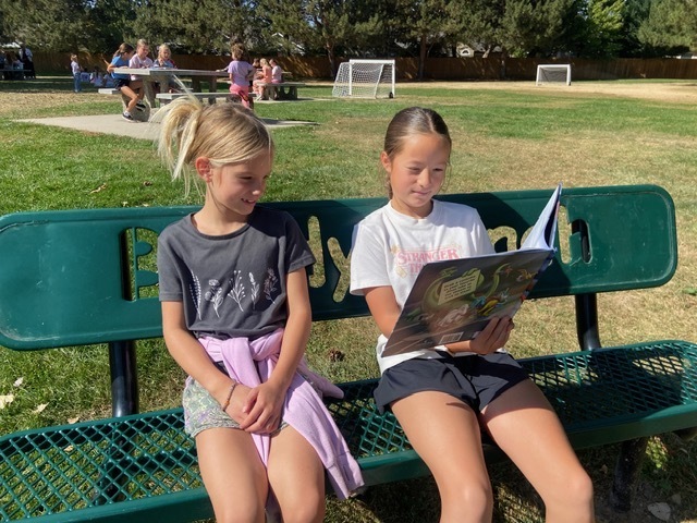 Kids reading outside