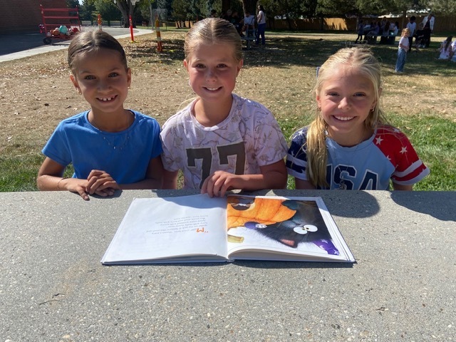 Kids reading outside