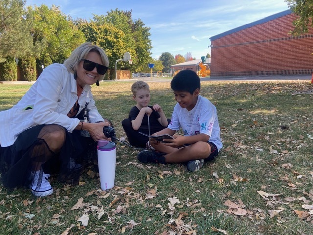 Kids reading outside.