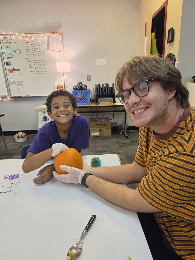 student and teacher with pumpkin