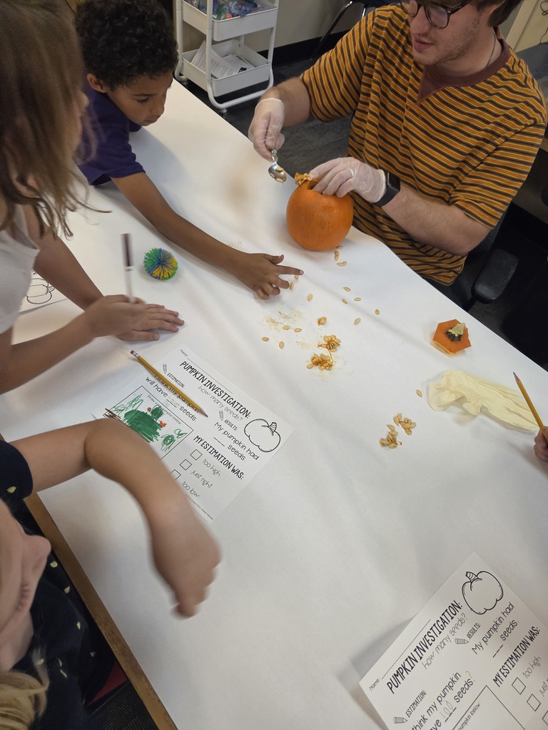 students and teacher investigating a pumpkin