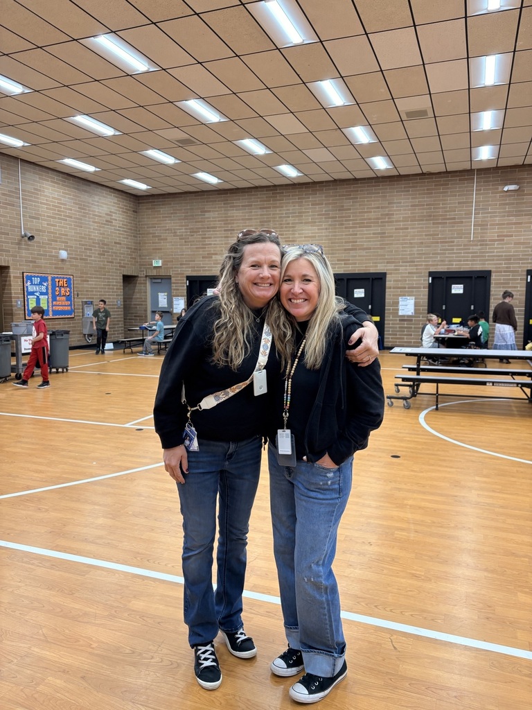 two teachers in black shirts and jeans