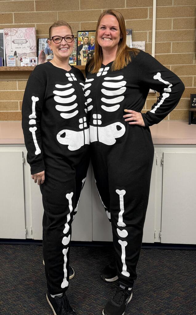 two women dresses as skeletons