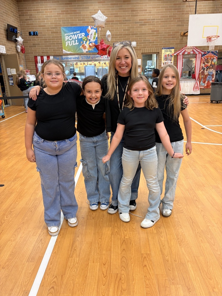 One teacher and 4 students all wearing blue jeans and black shirts