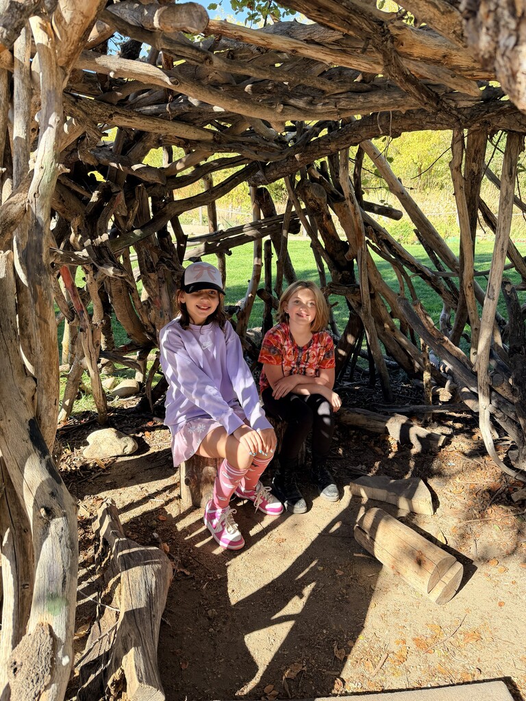 students in a wooden shelter