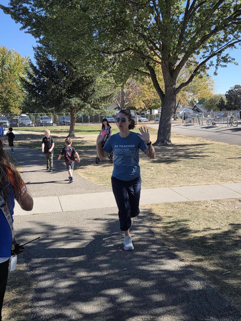 PE teacher running the track