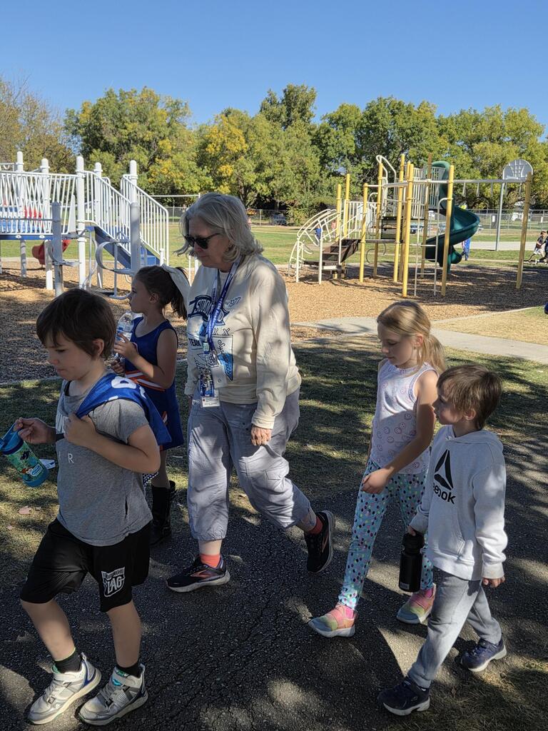 Students and principal walking the track