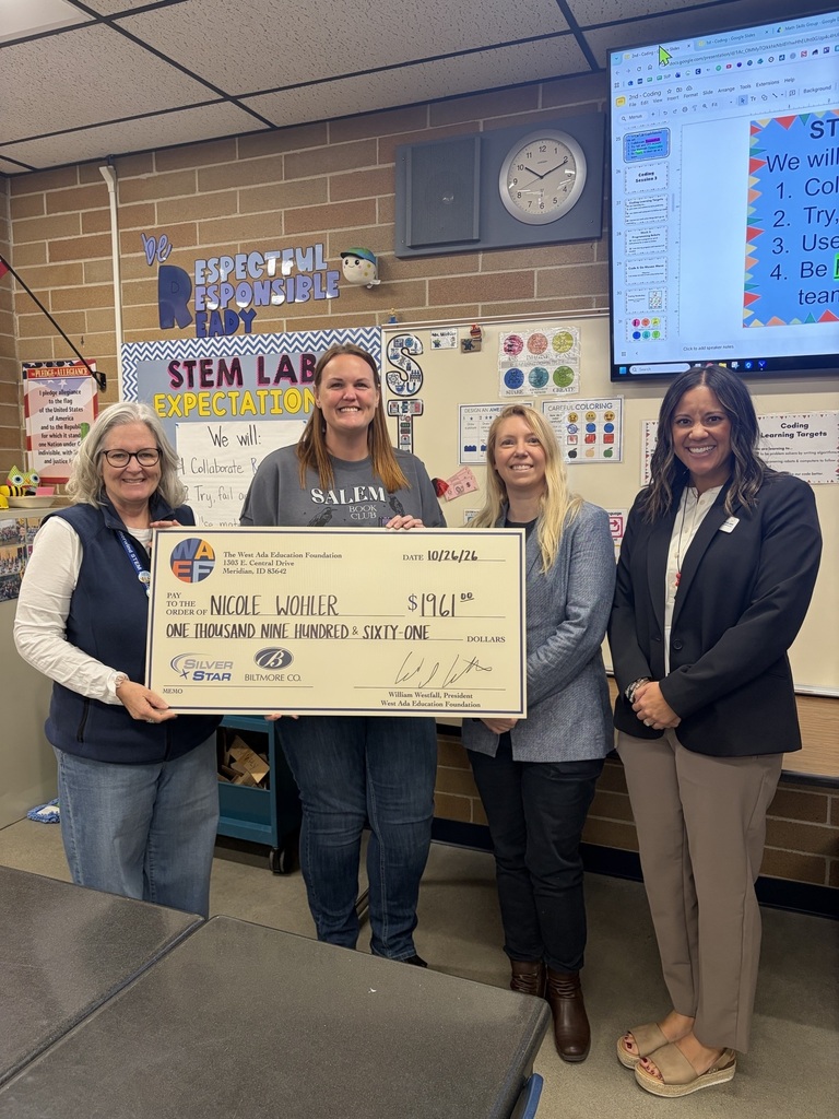 STEM Teacher with Grant Check
