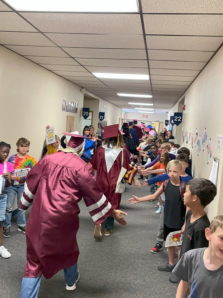 Grads walking the hallway (rear view)