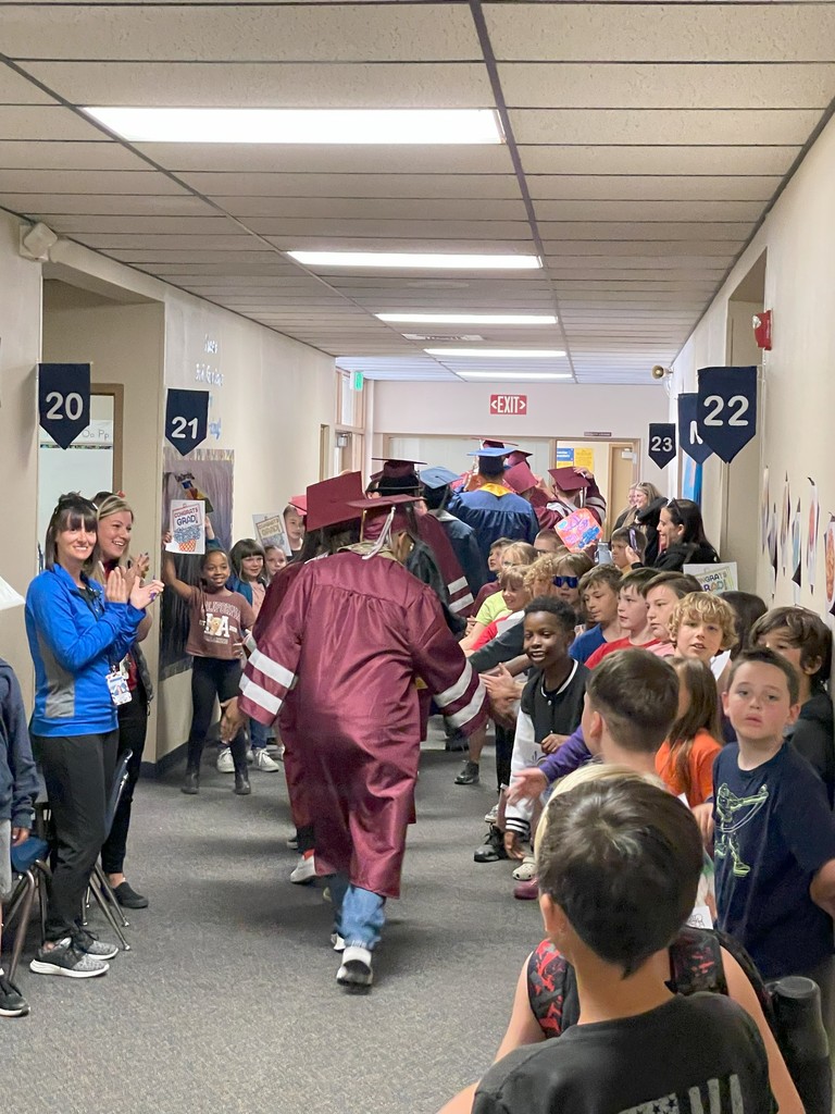 Grads walking the hallway (rear view)
