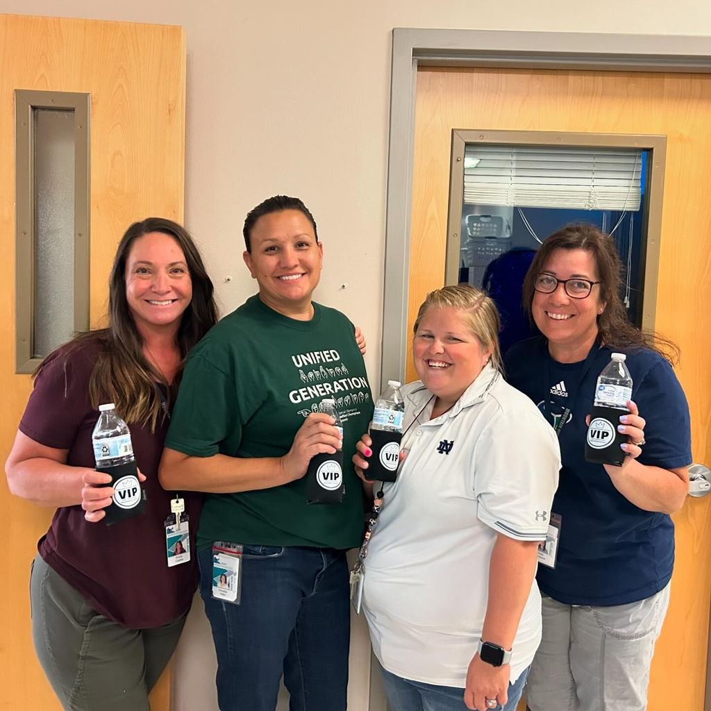 four paraprofessionals receiving koozies