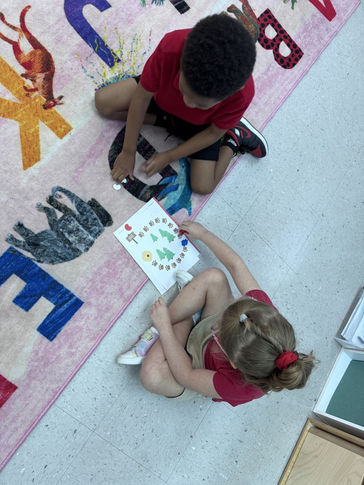 Ms. Kelli’s class using one-to-one correspondence by counting only the red beans and moving the bear to reach the honey