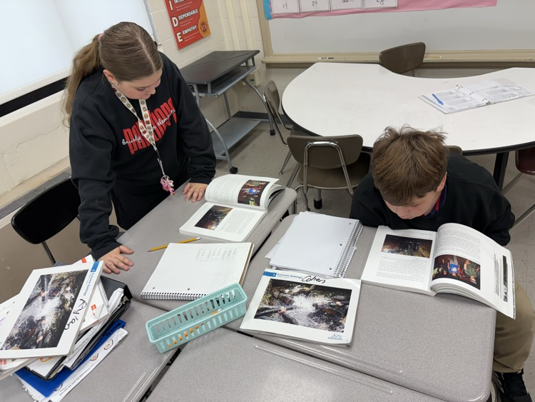 Students having great discussions and searching for evidence about opinion writings in ELA class! 📝