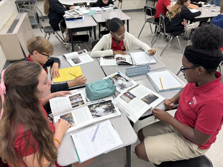 Students having great discussions and searching for evidence about opinion writings in ELA class! 📝