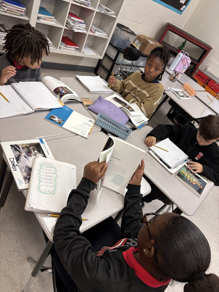 Students having great discussions and searching for evidence about opinion writings in ELA class! 📝