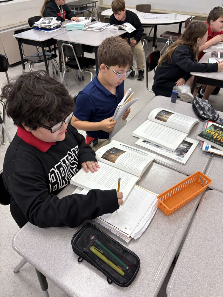 Students having great discussions and searching for evidence about opinion writings in ELA class! 📝