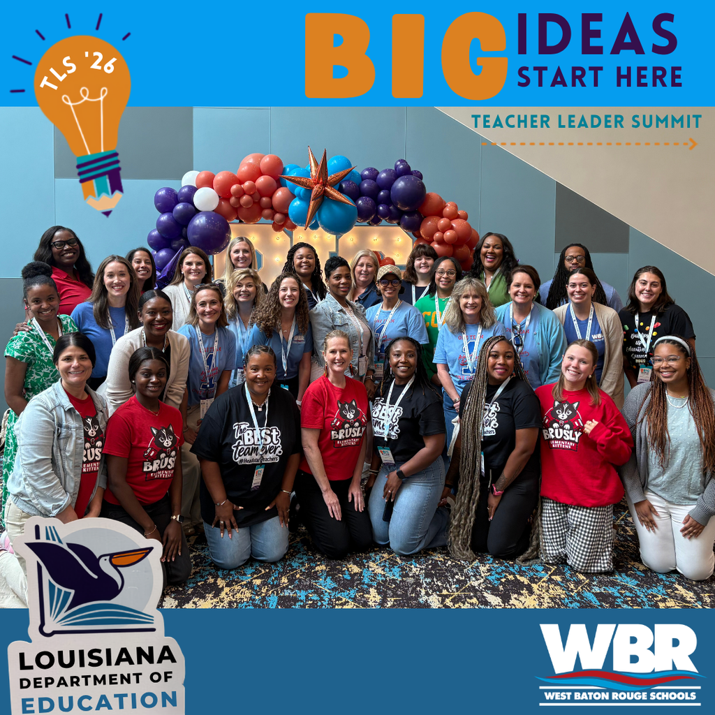 Group of teachers and leaders posing in a room with balloons and a light bulb graphic.
