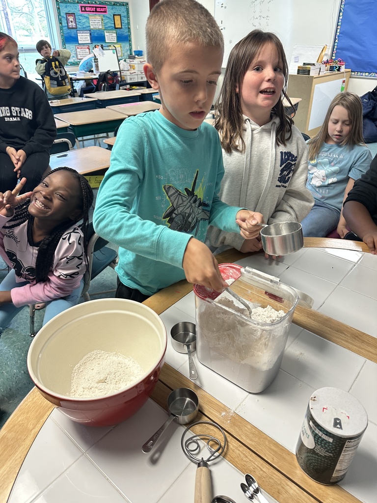 student measuring the flour