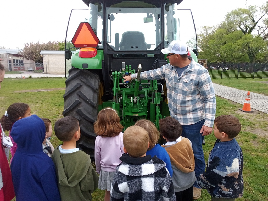 Mr. Reeves shows students farming equipment