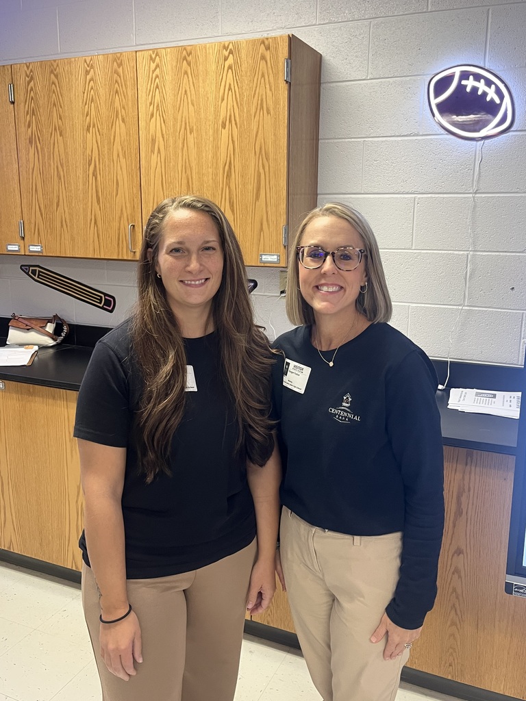 Two women from Centennial Bank, Ginger Foster and Molly McAlpin, stand together smiling in a West Carroll classroom."