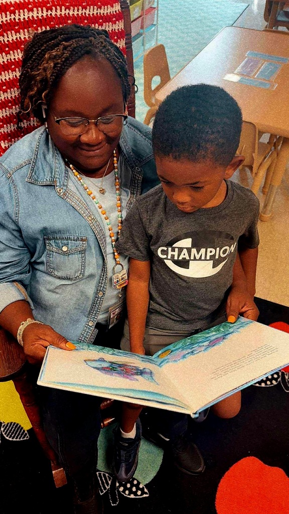 Sharlanda Emerson sits and reads aloud to a young PreK student, Kaiden Adkisson, at West Carroll Primary School as part of the new Drop Everything and Read program.