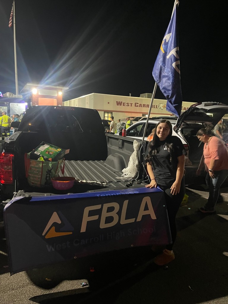 booth at boo bash for FBLA with fbla student standing by truck giving out candy