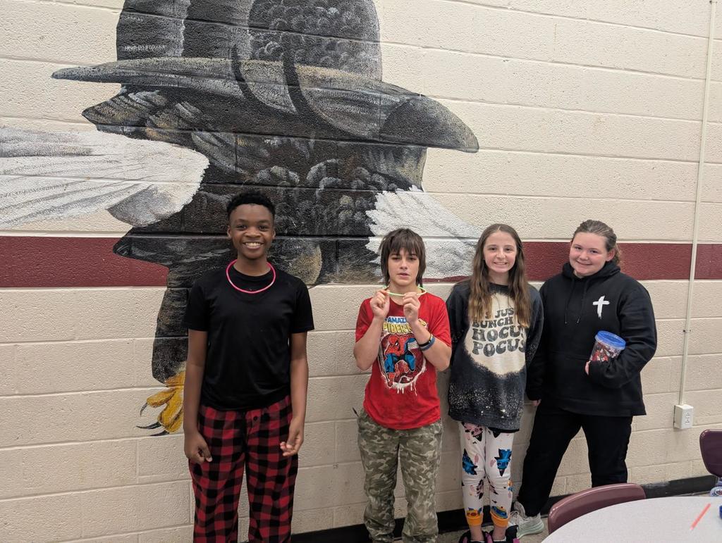 wces students participating in red ribbon week holding up prizes and dressed on special red ribbon days