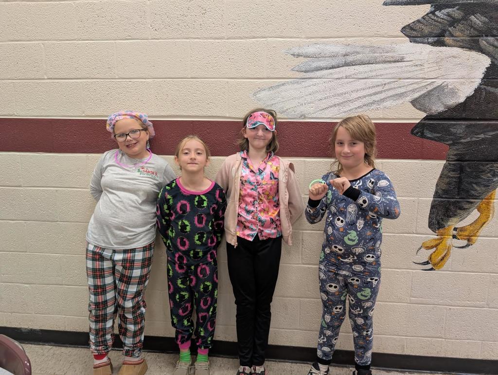 wces students participating in red ribbon week holding up prizes and dressed on special red ribbon days