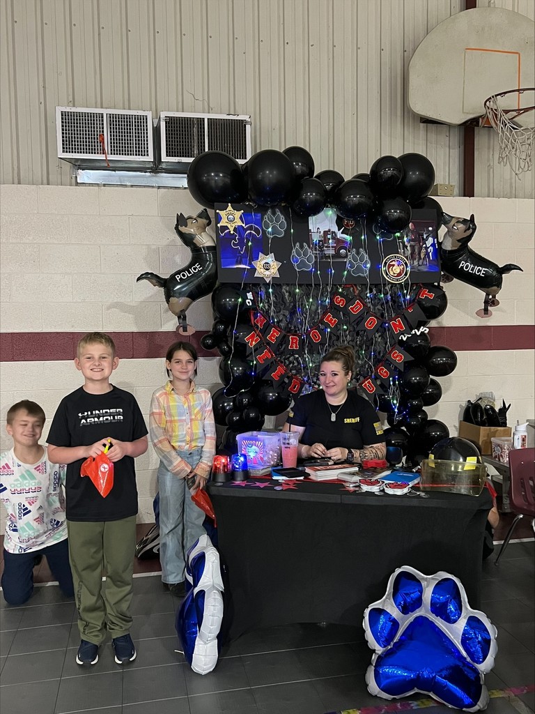 wces students participating in red ribbon week holding up prizes and dressed on special red ribbon days