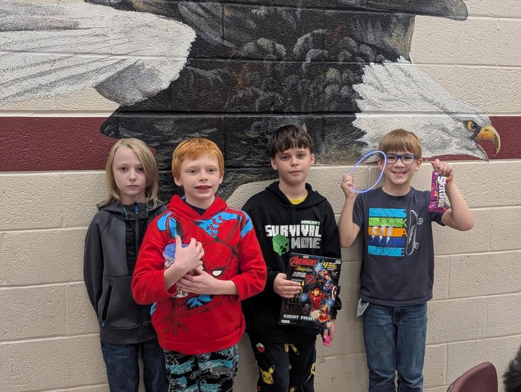 wces students participating in red ribbon week holding up prizes and dressed on special red ribbon days