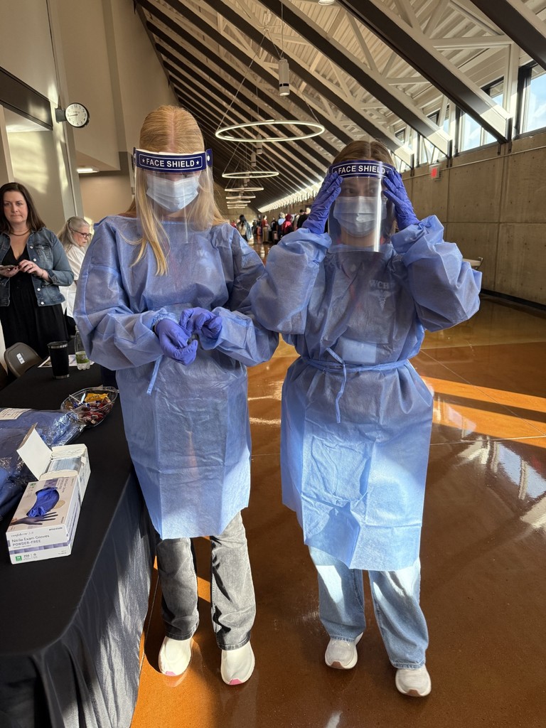 WCHS HOSA students attend The Discovery Summit and try on PPE. 